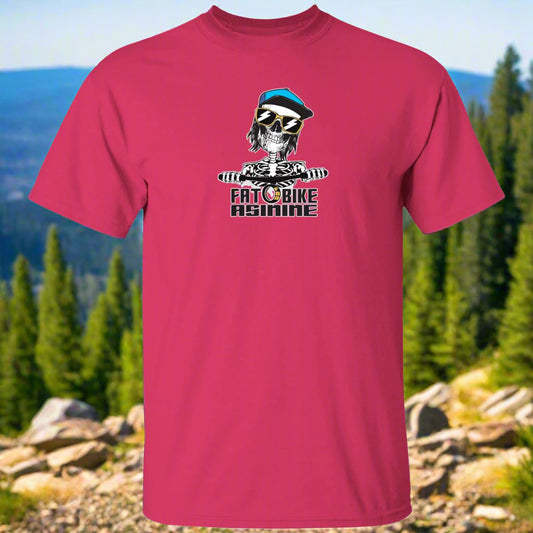 A pink t-shirt with a graphic print of a skull wearing sunglasses and the text 'FAT BIKE ASININE' on the front.