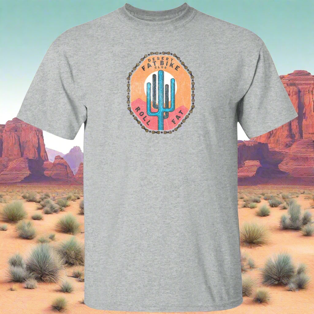 A gray t-shirt with a round neckline, featuring a colorful graphic of a cactus and the text 'Desert Bike Club' on the front.