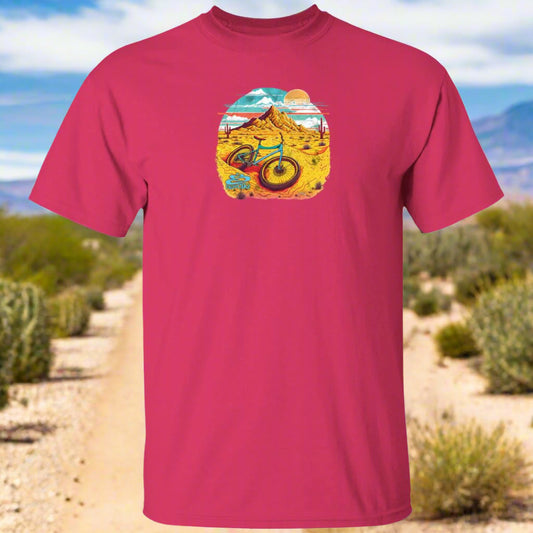 A pink t-shirt with a graphic print of a bicycle in a desert landscape.