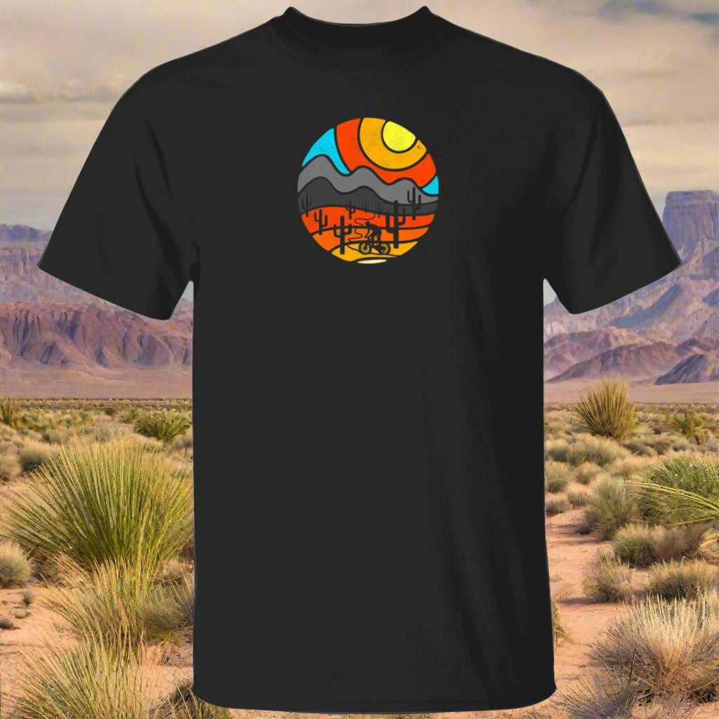 A black t-shirt with a colorful graphic print in the center depicting a desert scene with mountains and a sunset.