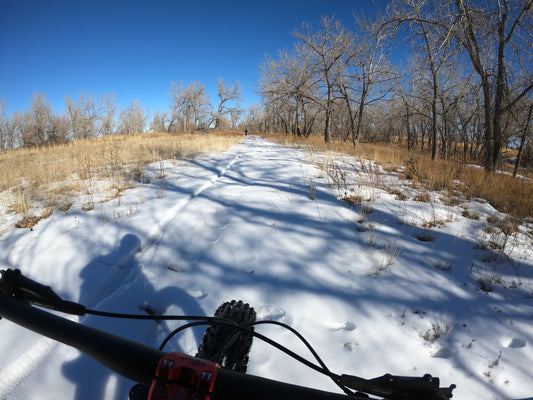 Fat biking in the winter snow. Riding a fat tire bike on snow